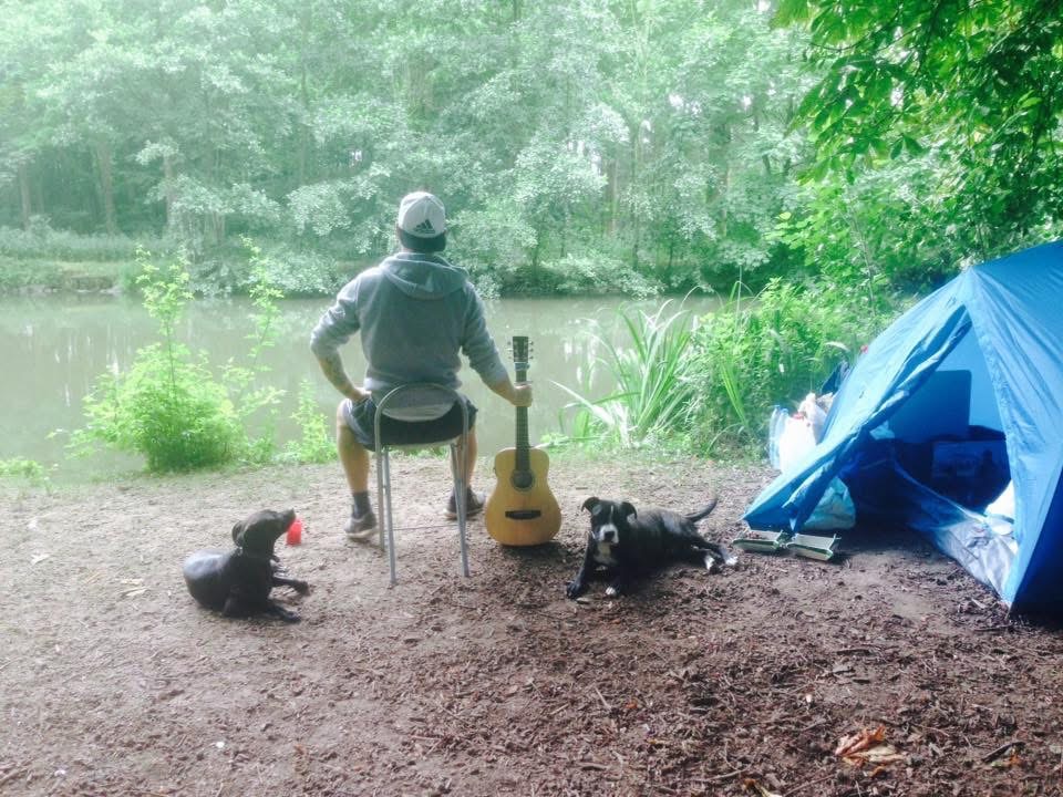 Camping by the river with the dogs and the guitar