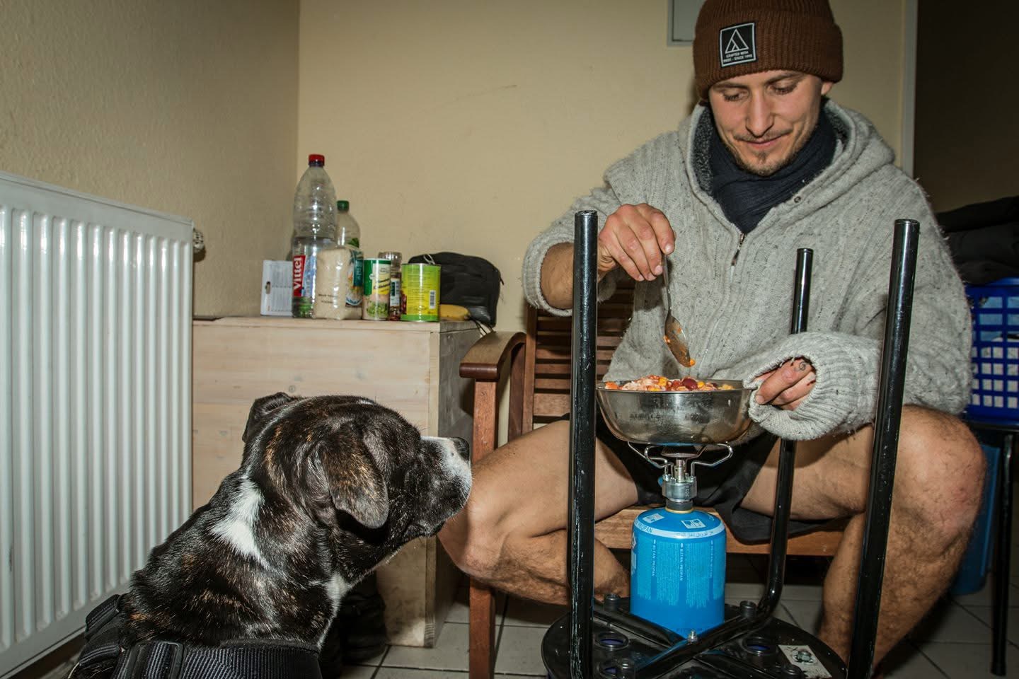 Cooking a meal next to a rescued dog